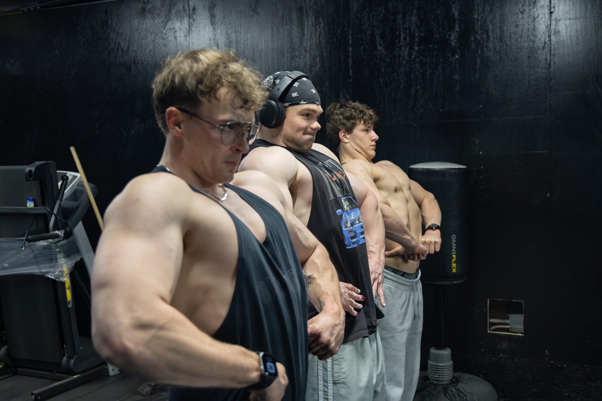From left, Connor Vicory, Ian Snopel, and Jay Weltzin-Trainer pose for their tripod camera at Solid Gym on April 1, 2026. (James McCurtis / SJMC)