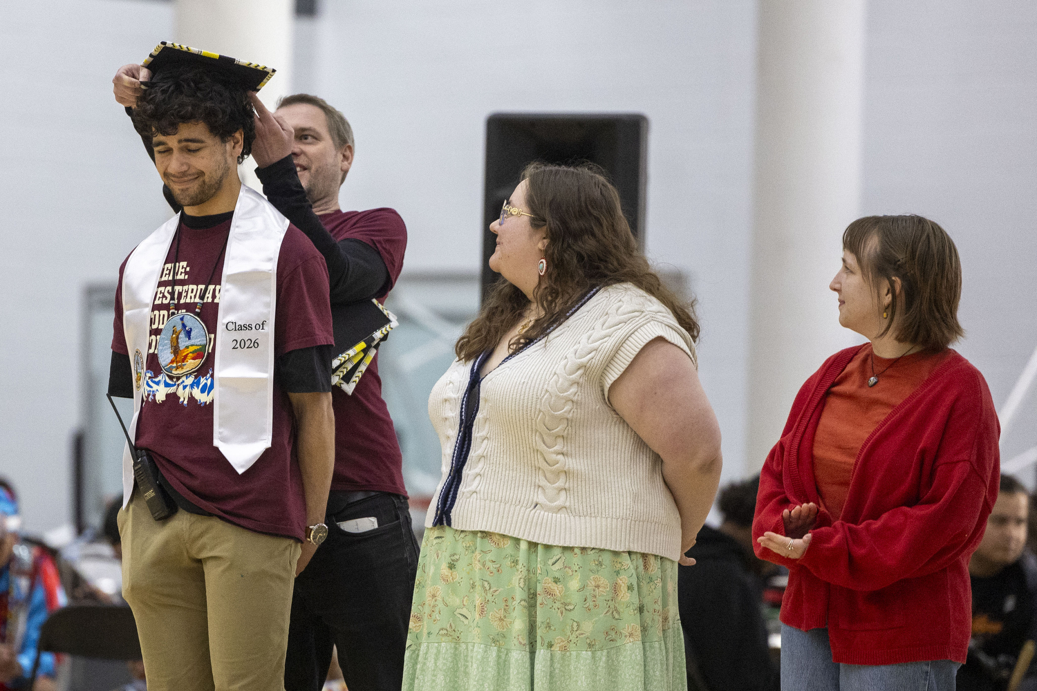 Joe Maxwell has his graduation cap placed on his head during the Powwow. Maxwell will be graduating in the spring with Masters of Science in Urban and Regional Planning.
