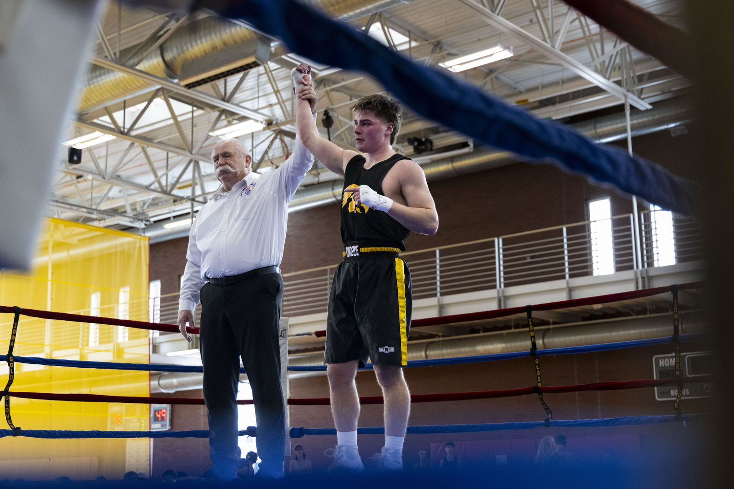 The officiant raises Samson Diener’s arm, declaring him the winner after his match against University of Illinois Urbana-Champaign boxer Trevor Gray during the Iowa State Annual Boxing Show in the State Gym at Iowa State University in Ames, Iowa on Saturday, Feb. 21, 2026. Diener will go on to fight in the National College Boxing Association Midwest Regionals, March 12-14, 2026. (Samantha DeFily/The Daily Iowan)