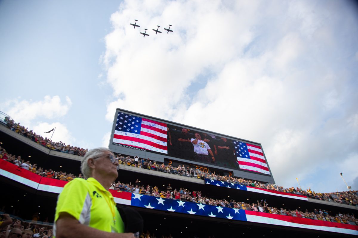 Fans cheer as jets fly over Kinnick Stadium before a professional exhibition baseball game between the Savannah Bananas and the Firefighters at Kinnick Stadium on Saturday, July 4, 2026. (Ethan McLaughlin/The Daily Iowan)