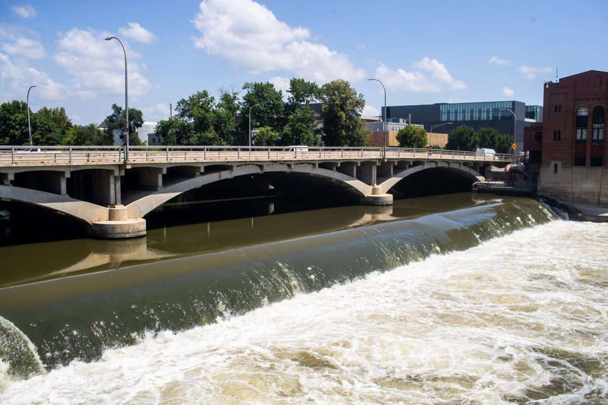 The Burlington Street Bridges are seen over the Iowa River as pedestrians and traffic cross it in Iowa City on Wednesday, July 15, 2026. The City of Iowa City received a federal grant of over $23 million towards replacing the two separate bridges with one unified bridge.
