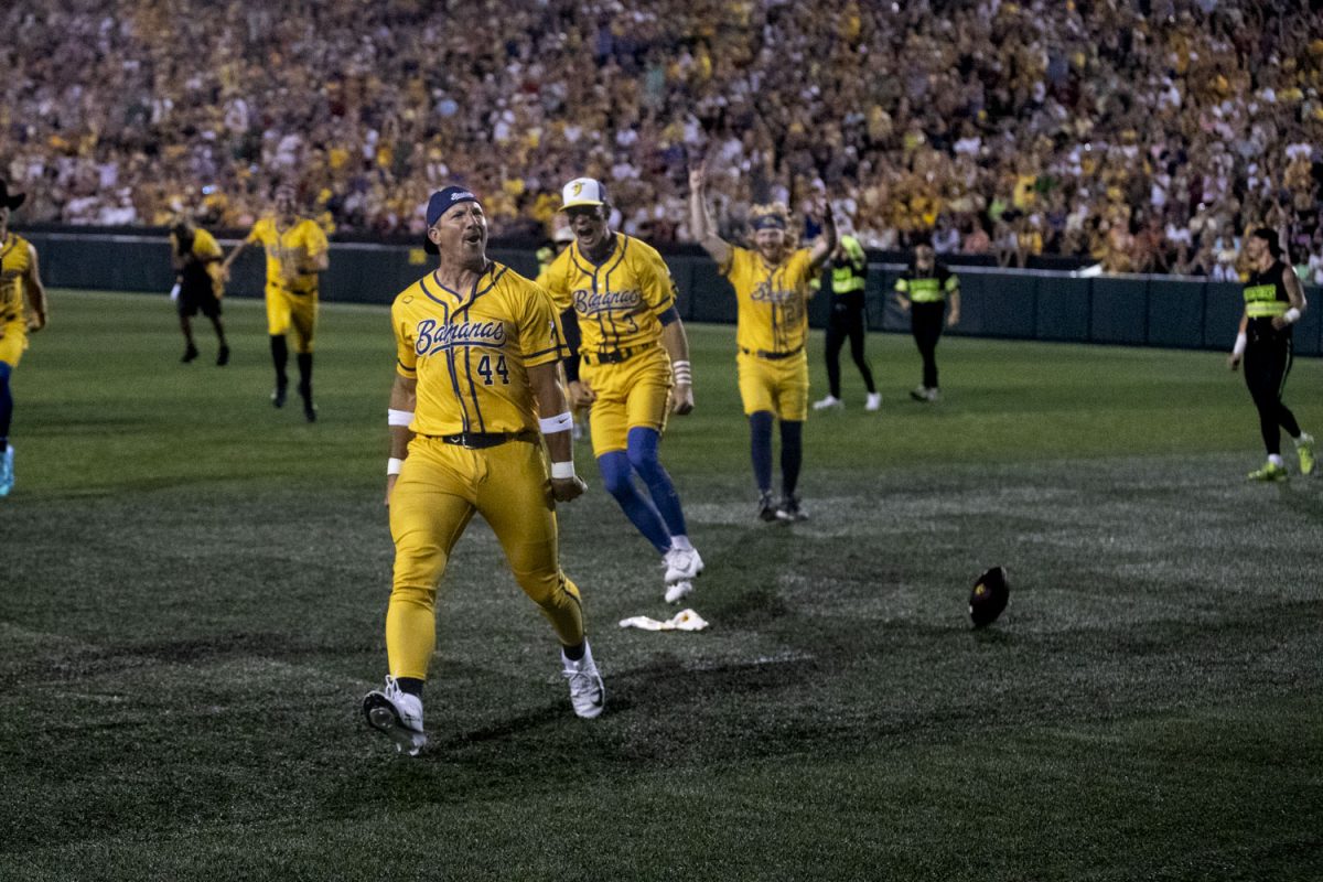 Banana Ball players briefly play football during a professional exhibition baseball game between the Savannah Bananas and the Firefighters at Kinnick Stadium on Friday, July 3, 2026.